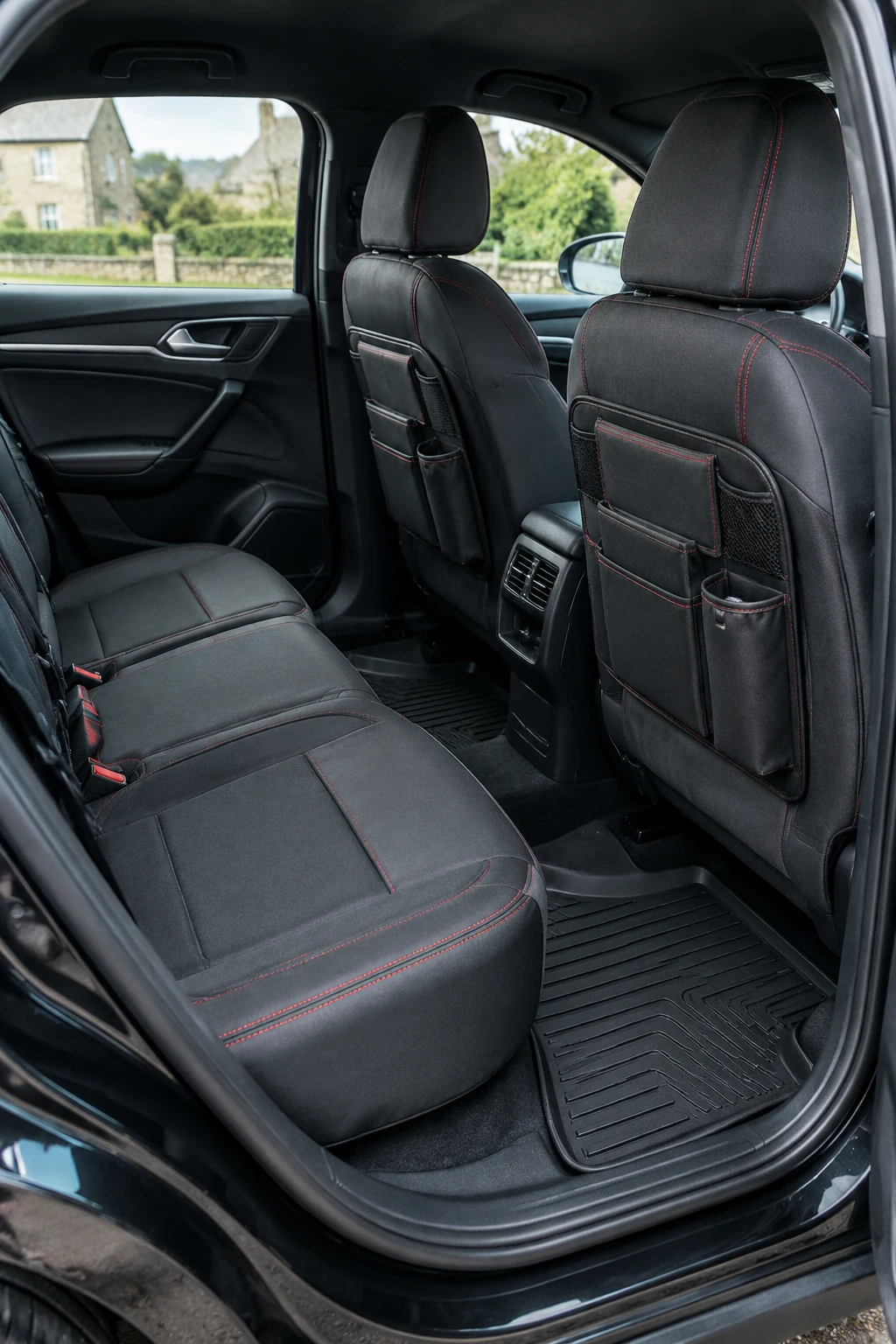 Clean car interior with black rubber mats and charcoal seat covers